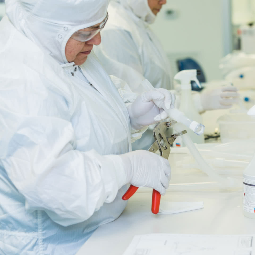 cleanroom technician crimping a fastener on single use assembly